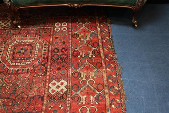 A large Persian carpet, 20ft 8in by 8ft 6in.